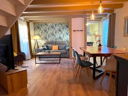 a living room with a table and a dining room at Sara Home in Chennevières-sur-Marne