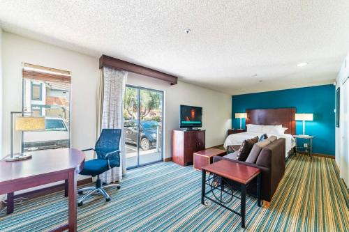 a hotel room with a bed and a desk and a couch at Metro PHX All Inclusive PROMO in Phoenix