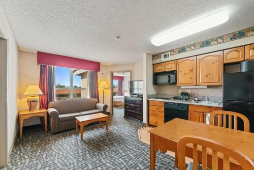 a kitchen and living room with a couch and a table at Scottsdale 2 bd 2 ba furnished apt 4 full beds in Scottsdale