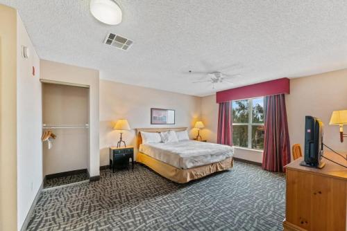 a hotel room with a bed and a television at Scottsdale 2 bd 2 ba furnished apt 4 full beds in Scottsdale