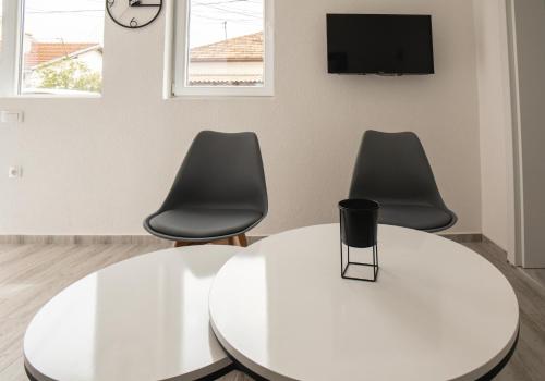 a room with a white table and two chairs at Fox Apartment in Gevgelija