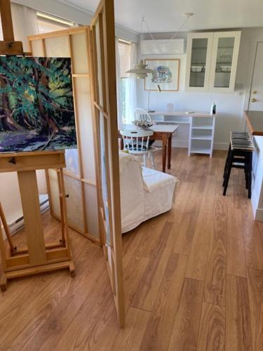 a living room with a table and a painting on the wall at Rent My Studio in Powell River