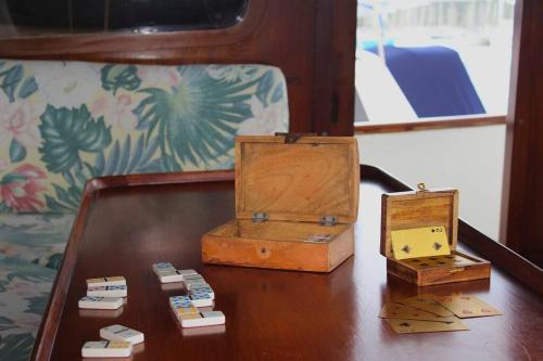 two wooden boxes sitting on a wooden table at Bateau Privatisé à la Marina du Marin in Le Marin