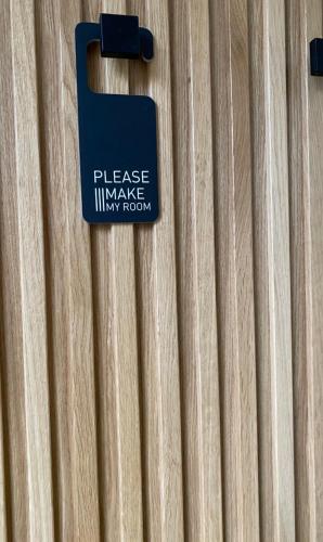 a sign on the side of a wooden door at Kaleo Chios Luxury Apartments in Chios