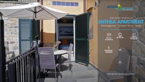 een patio met een parasol en een tafel en stoelen bij Estate Riomaggiore in Riomaggiore