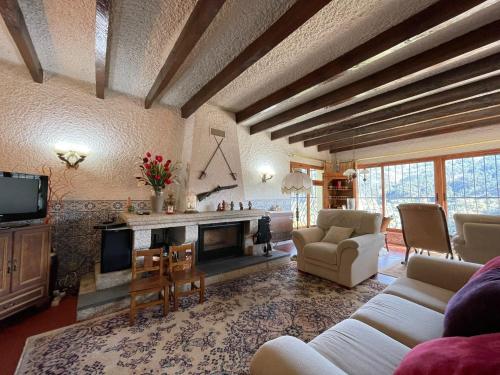 a living room with a couch and a fireplace at Casa d'Além - Gerês in Terras de Bouro