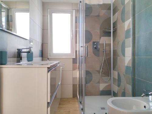 a bathroom with a shower and a sink at Villa Ina Lux in Fontane Bianche