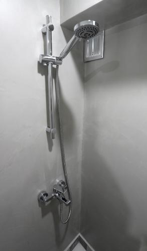 a shower in a bathroom with a shower head at Central Luxury Flat 1 in Chios