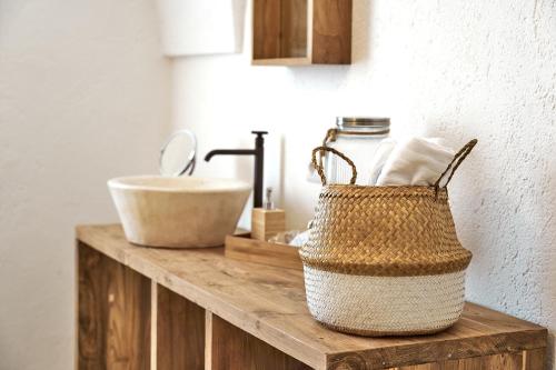 a basket on a counter with a sink in a bathroom at Il Trappetello in Monopoli
