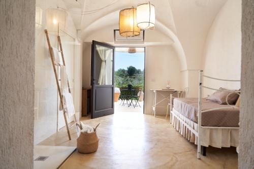 a bedroom with a bed and a door to a patio at Il Trappetello in Monopoli