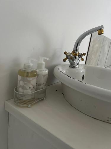 a bathroom sink with two bottles on a counter at Miami Gardens in Roodepoort