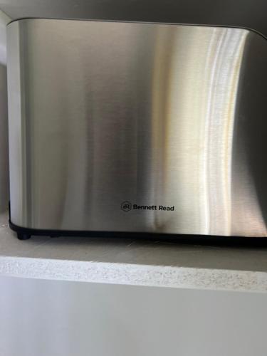 a stainless steel microwave oven sitting on top of a counter at Miami Gardens in Roodepoort