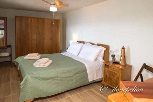 a bedroom with a bed with two towels on it at Uranus Blue Residence Agios Ioannis Papa Nero in Agios Ioannis Pelio