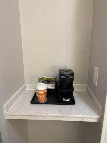a coffee maker on a shelf in a room at Comfort Inn Conroe in Conroe