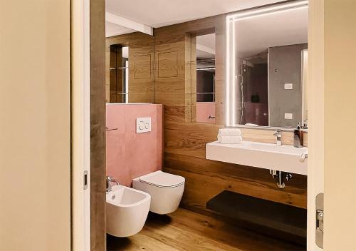 a bathroom with a sink and a toilet and a mirror at Al Pio Luxury Nest in Treviso