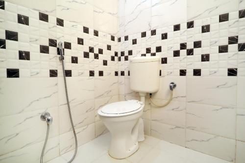a bathroom with a toilet and a shower at TRP VIVEK CONTINENTAL in Gwalior