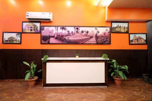 a large screen in a room with pictures on the wall at TRP VIVEK CONTINENTAL in Gwalior