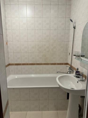 a bathroom with a bath tub and a sink at Your sweet home in Tashkent in Tashkent