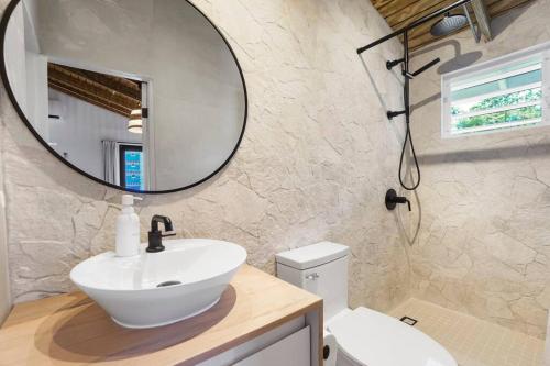 a bathroom with a sink and a mirror at Villa Costera Joyuda in Cabo Rojo