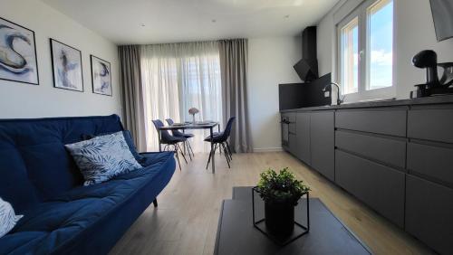 a living room with a blue couch and a table at Apartments Amare in Kali