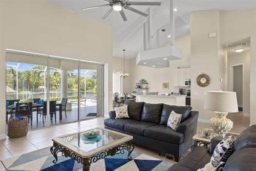 a living room with a couch and a table at Cape Serenity- Luxury Waterfront Villa with Kayaks and Bikes in Cape Coral