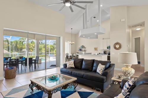 a living room with a couch and a table at Cape Serenity- Luxury Waterfront Villa with Kayaks in Cape Coral