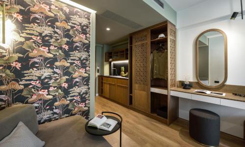 a living room with a wall with a floral wallpaper at Epineio Comfort Living in Litochoro