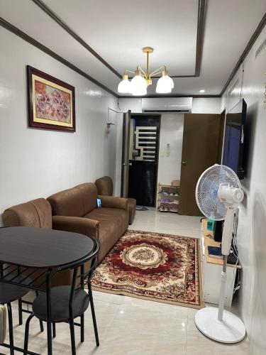 a living room with a couch and a table at Windmill Chimes in Rizal
