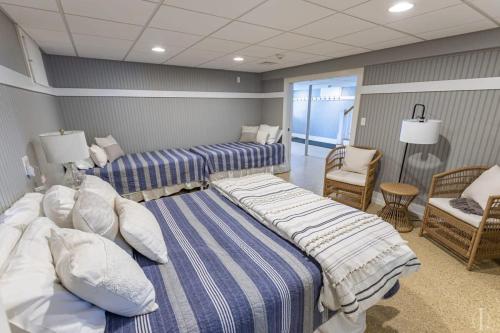 a hotel room with two beds and a chair at Beautiful Home 30 Feet from the Sand at Spofford Lake! in Chesterfield