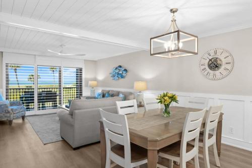 a dining room and living room with a table and chairs at Beach Villa 2614- Captiva Two Bedroom Premier Beachfront Residence in Captiva