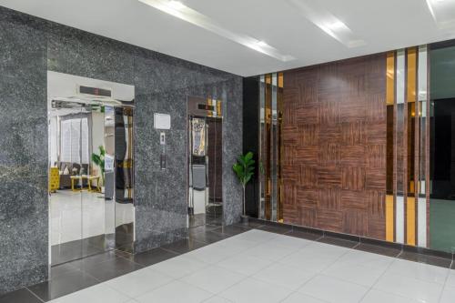 a lobby with wooden doors in a building at Afaq Tower in Manama