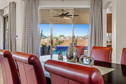 a dining room with a table and chairs and a large window at Serenity Peaks- Gorgeous Pet Friendly Villa in Scottsdale with Pool, Spa, and Bikes in Scottsdale