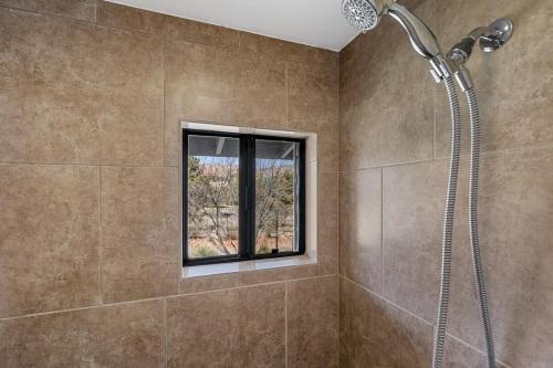 a bathroom with a shower and a window at Mid-century Ranch Home in Sedona with Fantastic Red Rock Views in Sedona