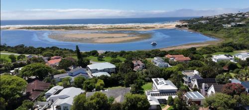 an aerial view of a town with houses and a body of water at Lasalle holiday home (Sun, Beach, Views, Fun for everyone!) in Plettenberg Bay