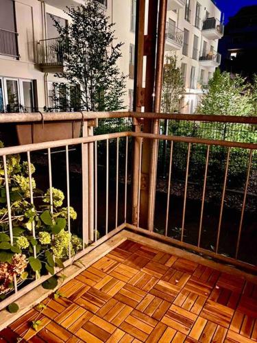 a balcony with a wooden floor and a plant at G Apartments Munich in Munich