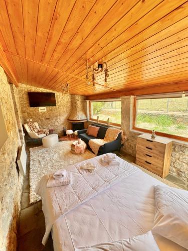 a bedroom with a large bed and a living room at Crown Luxurious Residence in Arachova