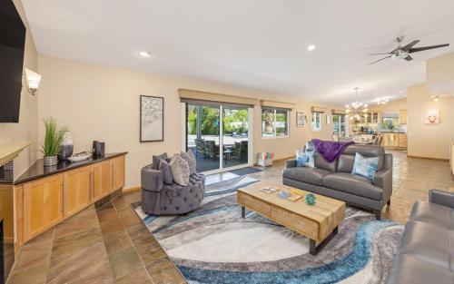 a living room with a couch and a table at Serenity Palms- Gorgeous Villa in Palm Springs in Palm Springs