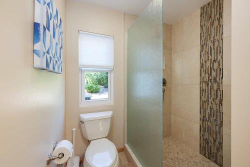 a bathroom with a toilet and a shower at Serenity Palms- Gorgeous Villa in Palm Springs in Palm Springs