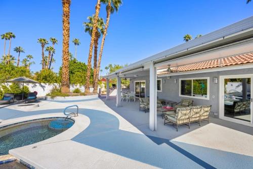a house with a patio and a swimming pool at Serenity Palms- Gorgeous Villa in Palm Springs in Palm Springs