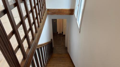 a stairway with wooden railings and a window at Gabiro in Bondy