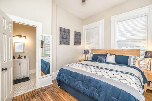 a bedroom with a large bed and a bathroom at Charming Condo in Historic Downtown Building in Wilmington