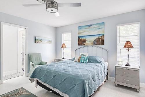 a bedroom with a bed with a blue comforter at Gorgeous Pool Home in Lake Murex Sanibel in Sanibel