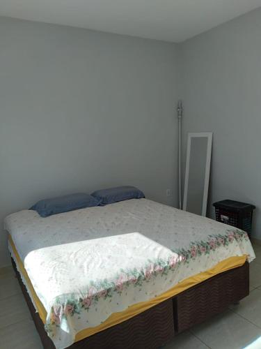 a bed with a blanket on it in a room at Casa primavera caldas novas in Caldas Novas