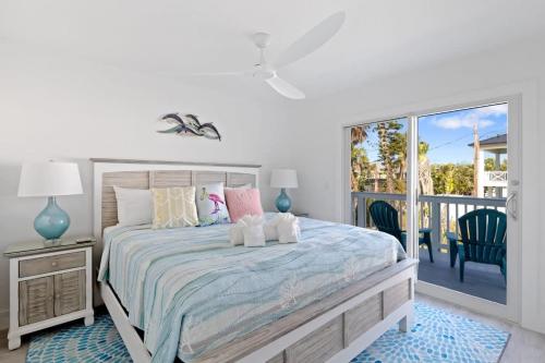 a bedroom with a bed and a balcony at Stunning Near Beach Residence on Palermo Circle in Fort Myers Beach