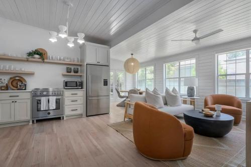 a kitchen and living room with a couch and chairs at The Ressman Haus at MarktPlatz with Hot Tub in Fredericksburg