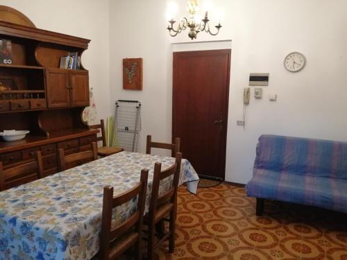 a dining room with a table and a chair at Appartamenti Fiumaretta MT 200 dalla spiaggia in Ameglia