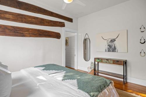 a bedroom with a bed and a antelope picture on the wall at The Downtown Studio 1 private hot tub in Fredericksburg
