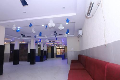 a lobby with a red couch and blue lights at TRP Rama Inn in Gwalior