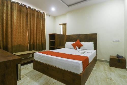 a bedroom with a large bed and a television at TRP Rama Inn in Gwalior