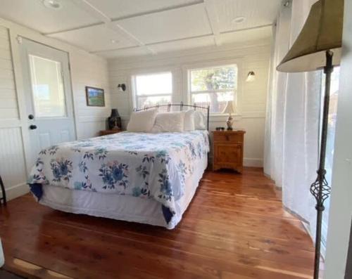 a bedroom with a bed and a wooden floor at Das Jager Haus Secluded Cabin pet friendly in Fredericksburg